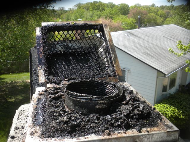 chimney cap removed to reveal soot filled chimney liner