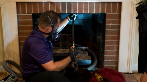 chimney sweep cleaning the chimney