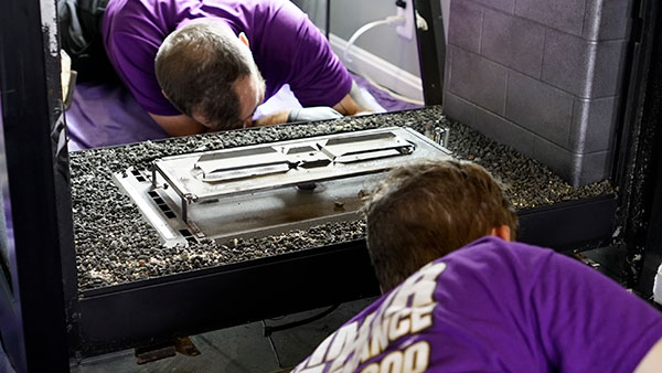 two men working on gas fireplace