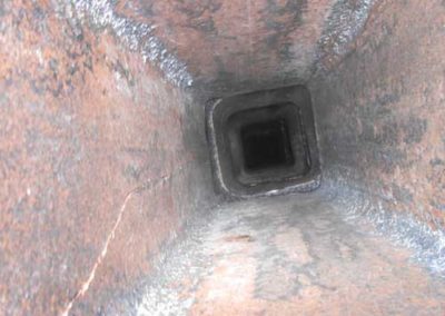 During - Puffy Creosote Removed from Flue Liner, Revealing Cracks in Liner